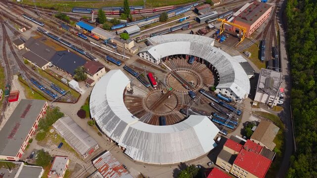 Aerial view of a historic railway roundhouse with a central turntable and locomotives on radiating tracks Prague, Prague, Czechia.