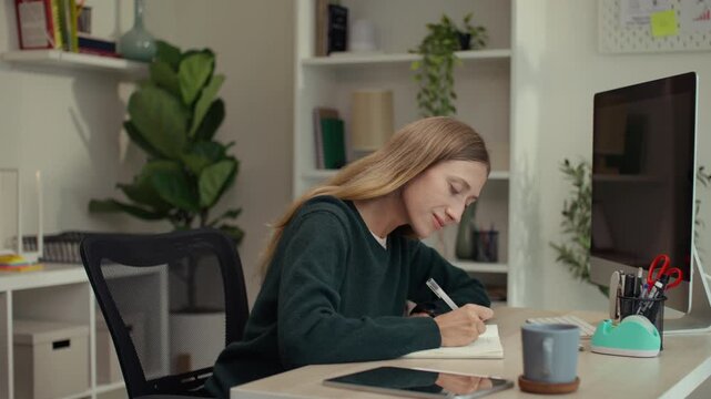 Young woman mindfully journaling and reflecting in her notebook, embracing self-care, manifestation, and intentional living, blending wellness rituals with modern slow living vibes