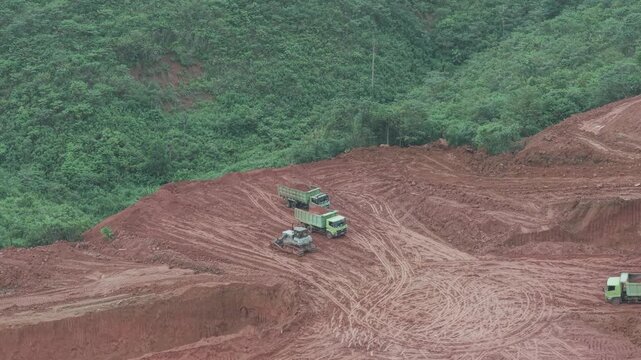 The process of unloading soil in road construction, a truck is loading soil into the truck bed