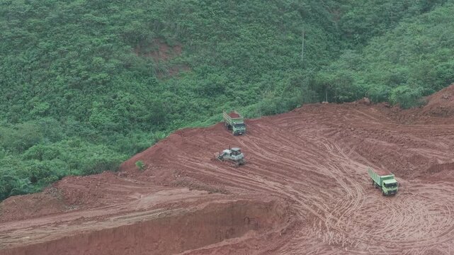 The process of unloading soil in road construction, a truck is loading soil into the truck bed