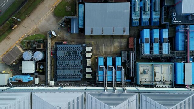 Drone view of modular data hall architecture and rooftop HVAC cooling units for IT infrastructure.