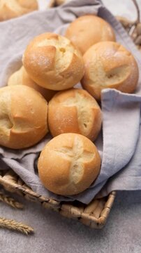 Freshly baked kaiser rolls in wicker basket
