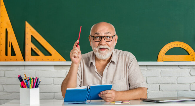 Teachers, green board. Happy school male teacher book. Portrait male teacher in classroom