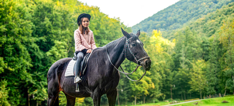 Horse. Child girl rides horse on the outdoors in the middle of the forest, park, trees, mountains