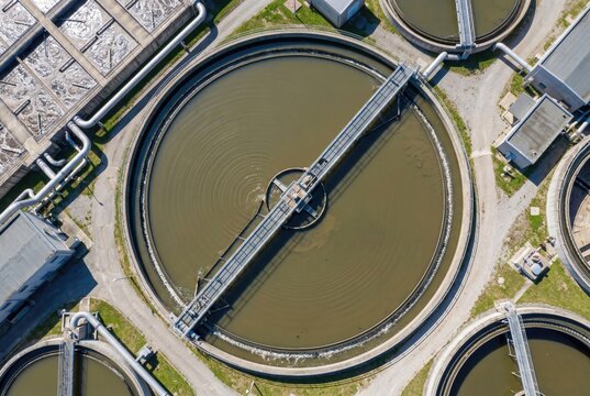 Drone shot of a large circular clarifier tank at a wastewater treatment facility