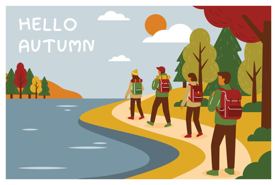 Group of friends hiking along a lake during autumn adventure