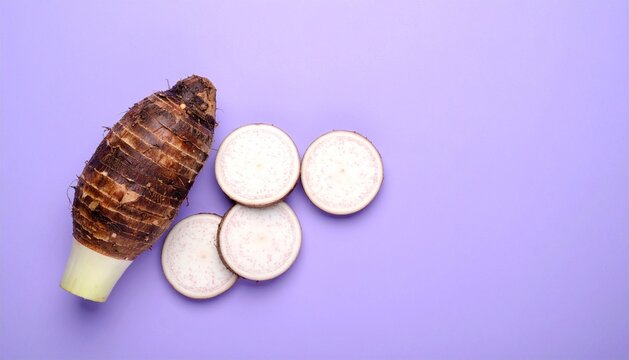 Fresh Taro Root and Slices on a Purple Background