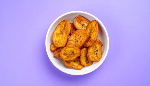 Delicious Fried Sweet Plantain Slices Served in a White Bowl on a Purple Background