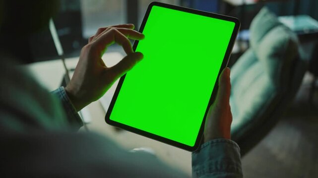 Businessman tapping chroma key tablet at corporate office. manager shopping online using green screen background pad at workplace. Man touch mockup digital device in company. smartphone. mobile phone