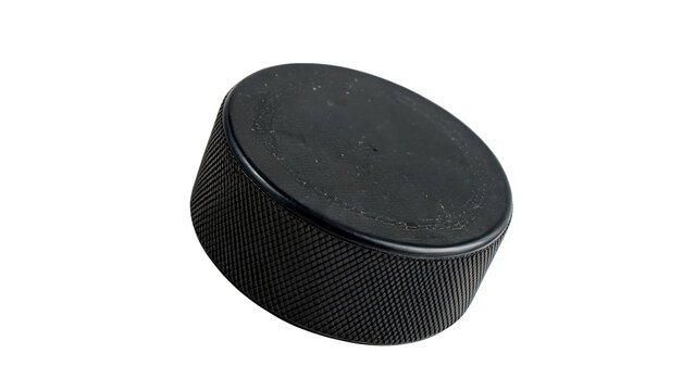 A standard solid black vulcanized rubber ice hockey puck sports game training equipment item isolated on transparent background
