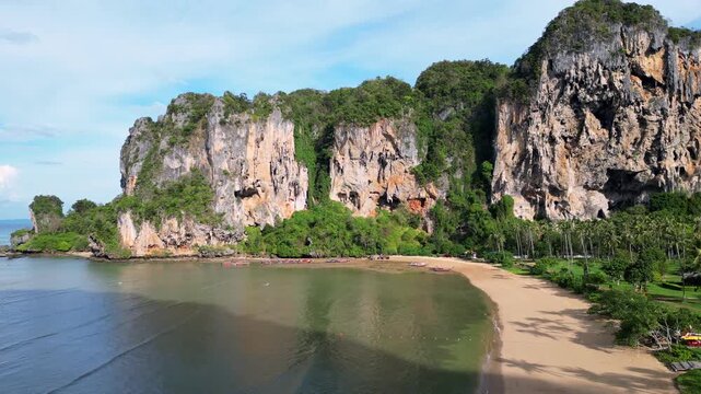 Krabi, Thailand : Aerial drone footage of tonsai beach in Railay of Andaman coastline in Krabi, Thailand. Taken with upward motion showing famous rock climbing area surrounded by karst 