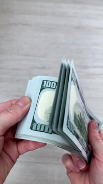 Vertical video. The woman counts the money. New bills. The financial result of your work and efforts. The theme of women's earnings, independence and self-reliance. financial independence