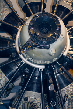 Front view of a vintage aircraft radial engine with cylinders and a red propeller hub. Aviation history and mechanics