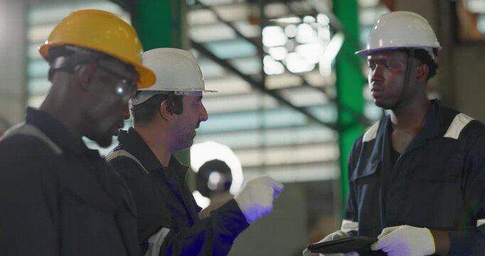 Factory technician inspecting auto parts, metal rod at machining station