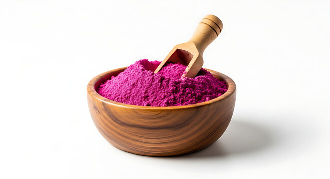 ​A vibrant magenta pitaya powder in a wooden bowl with a small scoop isolated on a white background.