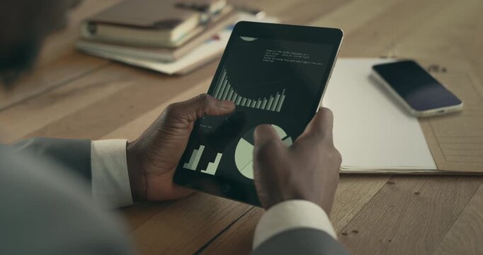 Reviewing business report on digital tablet