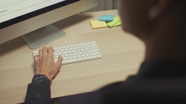 Modern man freelancer using AI voice assistant to make hands-free searches while working remotely, boosting productivity, embracing smart technology in a flexible work environment