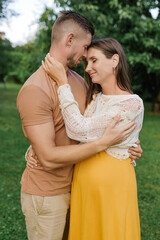 Fototapeta premium Tender Hug Of Expecting Couple In Garden