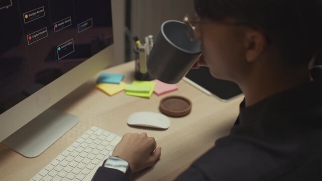 Modern man freelancer working remotely from home office, using a laptop to manage outsourced digital tasks and collaborate with global clients, embracing the freedom to work anytime and anywhere