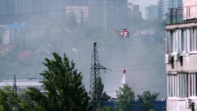 Firefighting helicopter dropping water on a fire after an airstrike in Kyiv, Ukraine.