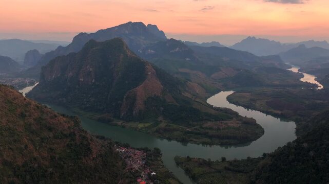 Beautiful Sunset in Nong Khiaw, a drone shot of picturesque Mountain Town on the Nam Ou River in Laos, Southeast Asia