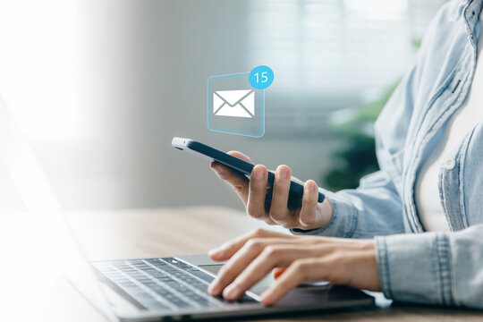 Hand of woman using smartphone for email with notification alert.