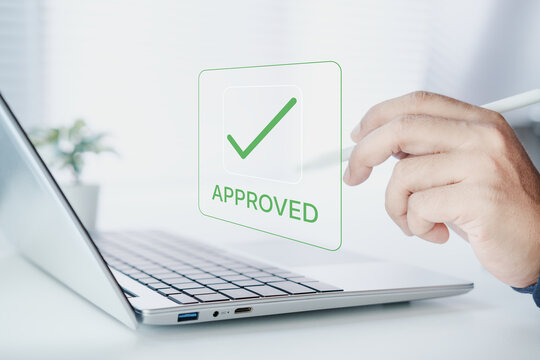 Business professional approving digital document on laptop with green checkmark interface, online workflow verification, success approval process for corporate task management and compliance system