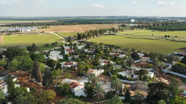 Aerial drone view of the reconstruction efforts in Kibbutz Kfar Aza. The footage shows new construction sites, heavy machinery, and the building of the Young Generation neighborhood as the community p