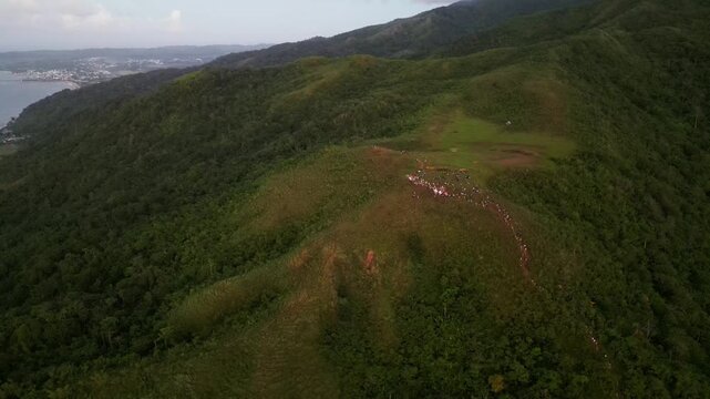 Scenic aerial orbit of Mount Lantad in Bato, Catanduanes with grassy summit, forested mountains, and tropical landscape