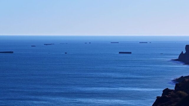 Distant view of D-Day landing caissons near Normandy coast, France