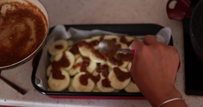 A fresh and vibrant close-up video demonstrating the step-by-step preparation of zucchini for cooking. The footage captures washing, trimming, slicing, and seasoning the green squash