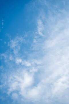 Bright blue sky with soft, wispy clouds creating a serene atmosphere.