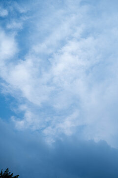Serene blue sky filled with soft, fluffy clouds creating a peaceful atmosphere.