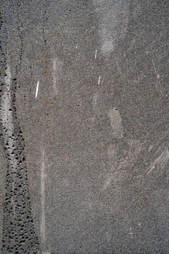 Close-up of textured gray stone surface with natural patterns and variations.
