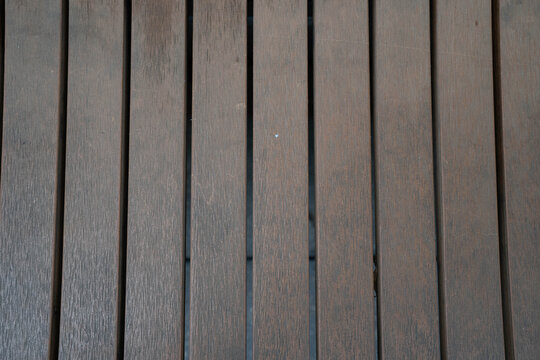 Close-up of dark wooden slats, showcasing texture and natural grain patterns.