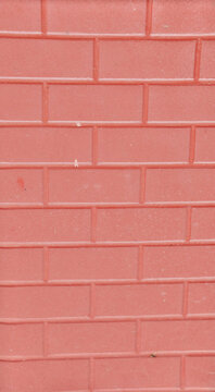 Close-up of a coral-colored brick wall showcasing a textured surface.