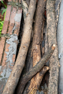 A textured arrangement of wooden logs and bricks in natural tones.