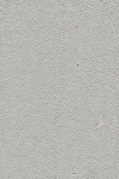 Textured light gray concrete wall surface with subtle variations.