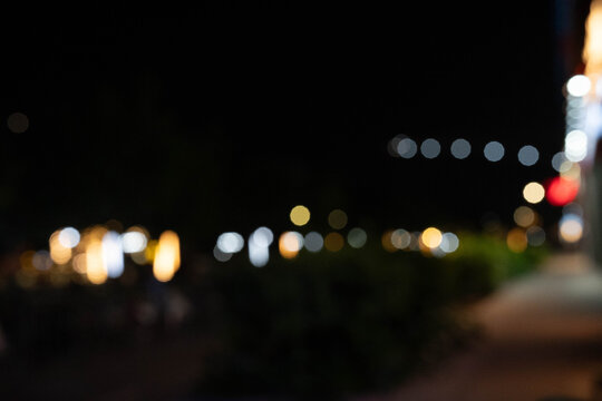 Abstract night scene with colorful blurred lights in a vibrant urban setting.