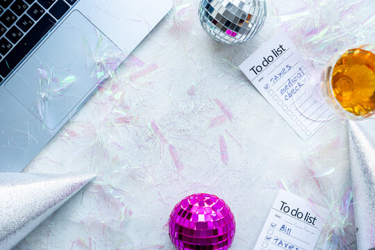 Admin night party - work with fun. Top view of laptop with confetti and disco ball