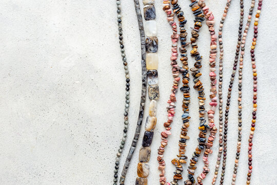 Necklaces of many gemstones beads and pearls, top view. Jewelry concept.