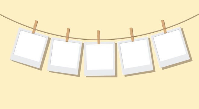 Five blank instant photo frames hanging on a thin rope with wooden clothespins against a warm beige background.