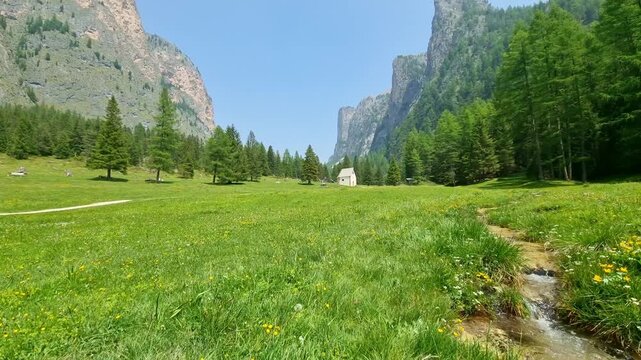 Mountain stream passing through beautiful Vallunga valley Langental in Val Gardena, Dolomites, Italy, in springtime