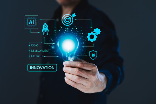 Businessman holding glowing light bulb with innovation, artificial intelligence and business growth interface