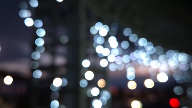 Lights bokeh night, hanging string lights illuminating an outdoor area at twilight, creating a festive magical atmosphere