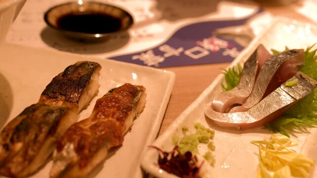 Traditional Japanese Cuisine with Grilled Mackerel and Fresh Sashimi Platter