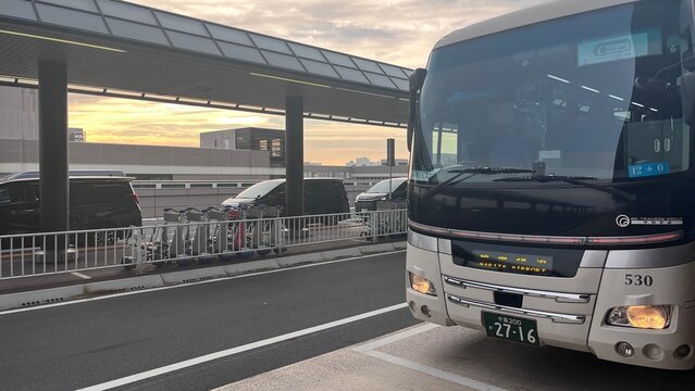 Narita International Airport (NRT) shuttle bus terminal with Be-Transse Group airport limousine parked for passengers during sunset - Chiba, Japan, October 29, 2025