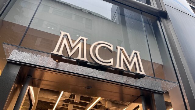 MCM luxury fashion boutique exterior signage and architectural glass storefront located near the Max Mara flagship building in the Shinsaibashi district - Osaka, Japan, October 16, 2025