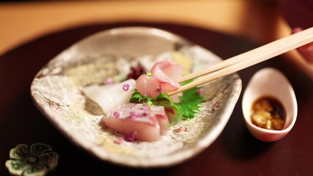Fresh Sashimi Platter Being Dipped into Soy Sauce with Chopsticks