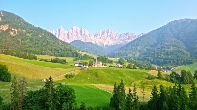 Iconic landscape in Val di Funes, Italy, with famous Santa Maddalena village and Odle mountains in the background, in Dolomites, South Tyrol, at sunset, in springtime